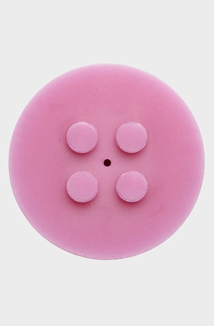 Pink round candle with four raised areas on a neutral background. Simple and vibrant, suitable for stacking. Ideal for creative use.